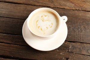 Cup of coffee latte art on wooden background