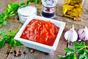 tomato sauce in white bowl and on a table