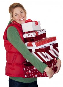 A woman with an armful of presents after going christmas shopping. Photo isolated on a white background