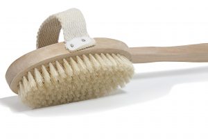 An exfoliating skin brush isolated on a white background.